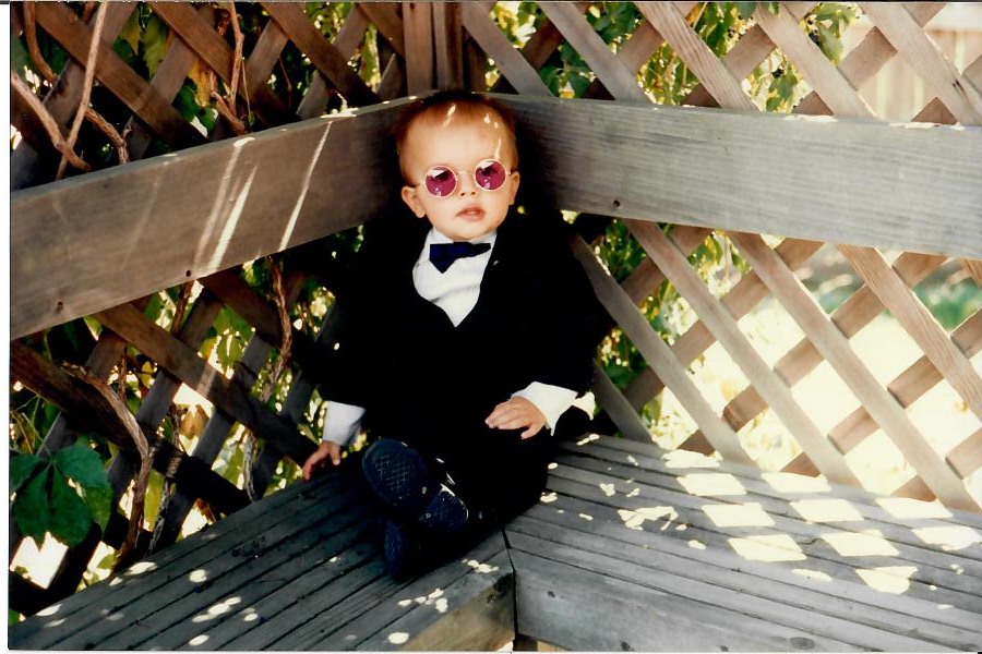 Brandon dressed up in sunglasses as a child