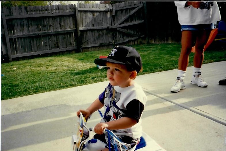Brandon with a bicycle as a child